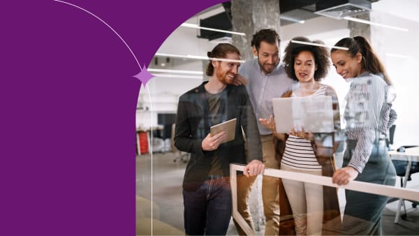 Coworkers collaborating during a team meeting with on a notebook