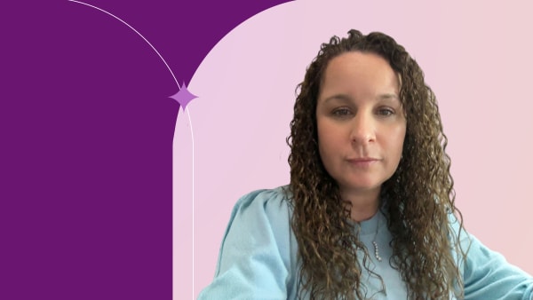 Mona standing, wearing light blue shirt.