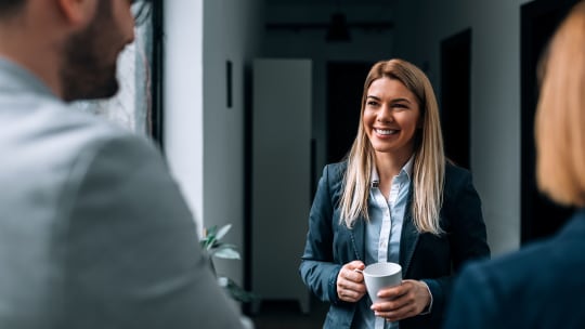 Coworkers talking in office