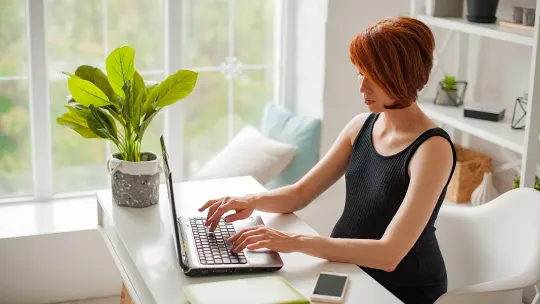 woman typing on a laptop