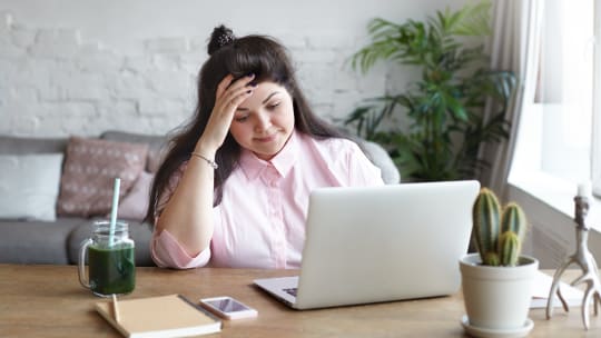 woman ovewhelmed at her desk