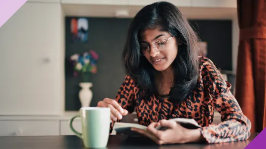 Person immersed in reading a book on confidence