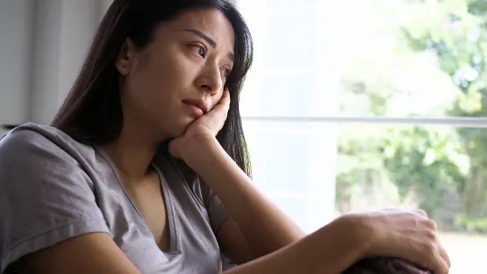 Sad woman looking out window