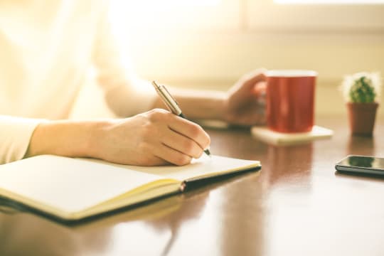 Woman Writing in Journal