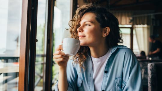 woman enjoying coffee at cafe