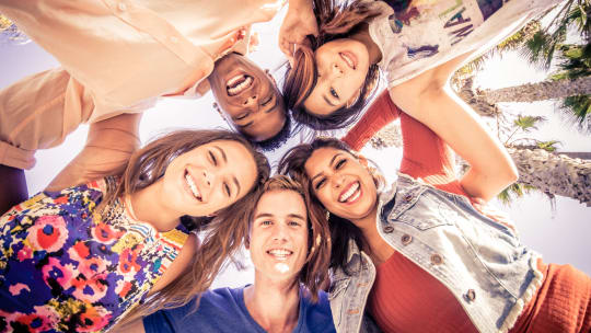 group of people in circle looking happy