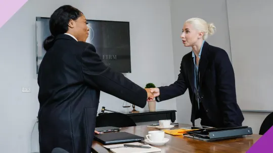 Candidate and interviewer shaking hands, illustrating how to answer “What is your desired salary?”