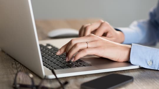 Woman typing on computer