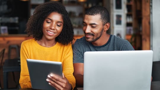 Two people looking at a phone