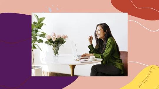 woman smiling at laptop.