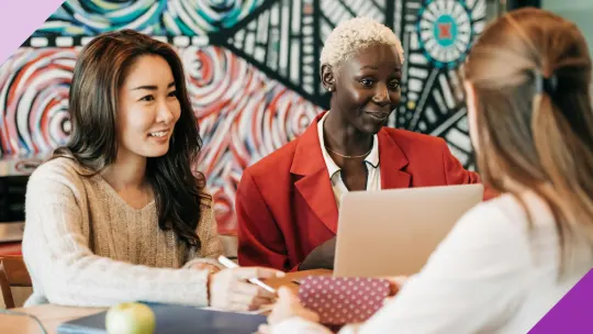 Coworkers in an office setting; illustrating how to respond to a compliment at work