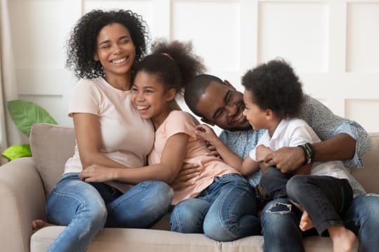 happy family hugging on a couch