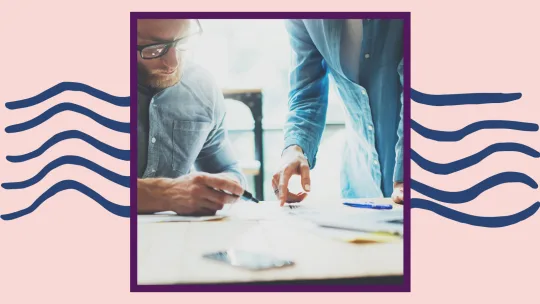 two people working at a table.