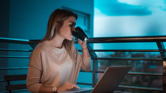 woman working overtime from her patio