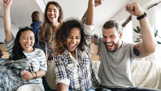 people cheering over a game at a party