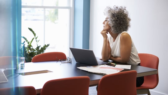 Woman thinking at kitchen table