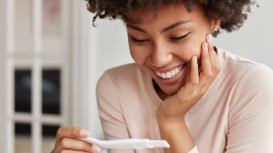 pregnant woman checking pregnancy test