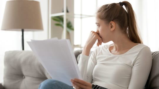 Sad woman holding paper