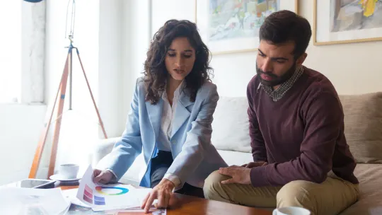 Interior Designer talking to a man over prints