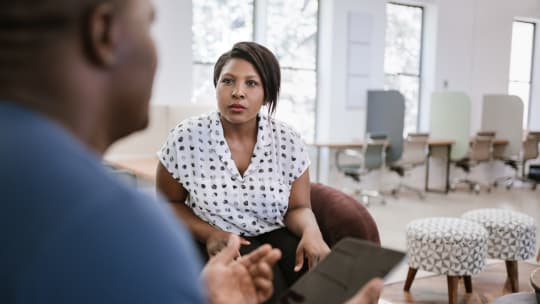 Man speaking at desk