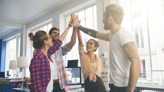 group of young adults celebrating success