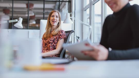 Woman talking to colleague