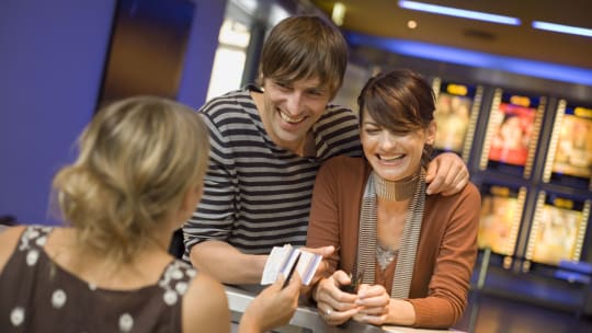 couple buying tickets at the theatre