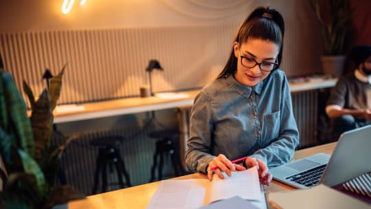 entrepreneur reading and taking notes