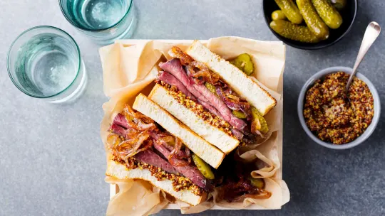 Sandwich with roast beef in wooden box. Top view.