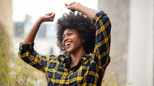 carefree woman dancing outside