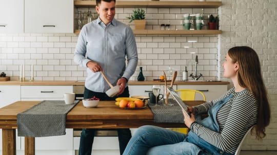 Pregnant woman and partner in kitchen