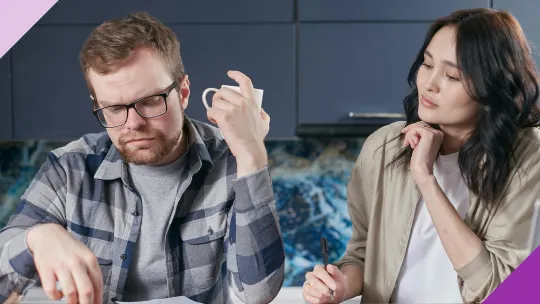 A couple assessing their finances, illustrating the effects of financial stress on marriage