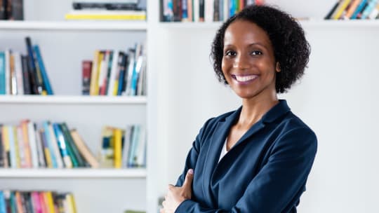 woman standing in front of a bookcase
