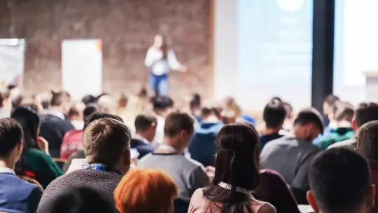 woman speaking at a conference