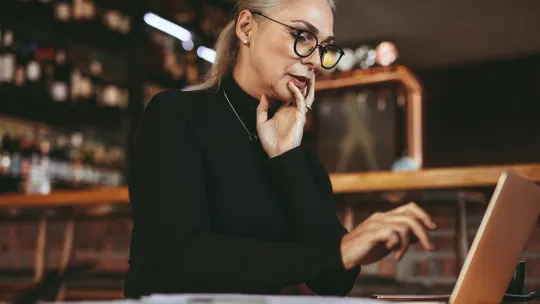 Older woman applying to jobs on the computer