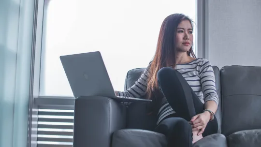 woman with laptop thinking