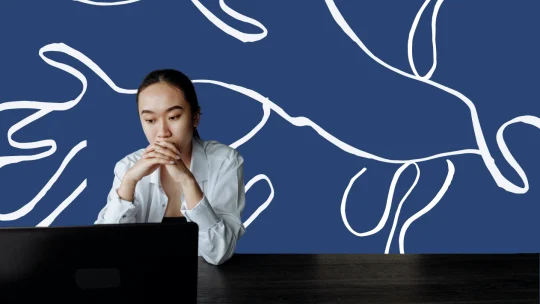 woman looking apprehensively at computer