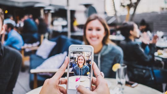 woman using phone for social media