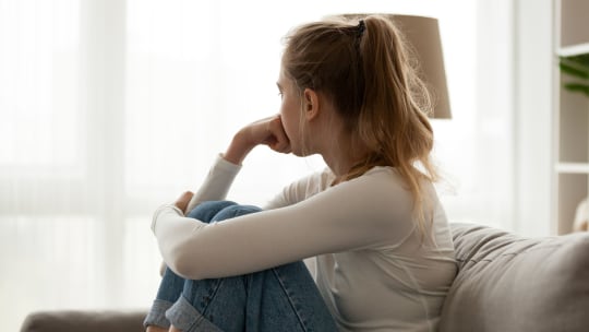 sad woman sitting on park bench