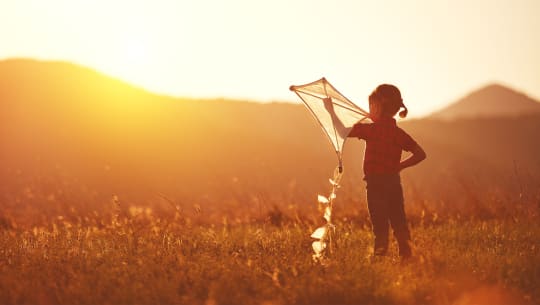 Young girl flying a kite