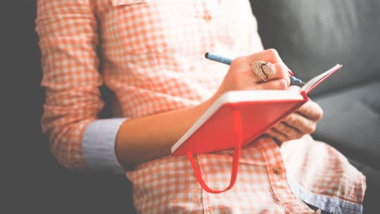 woman writing in a notebook