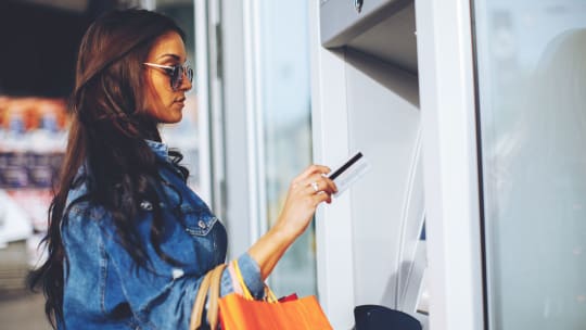 Millennial woman holding debit card