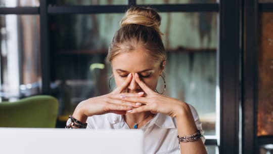 exhausted woman sleeping at her desk