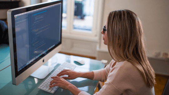 App developer sitting at desk looking at computer