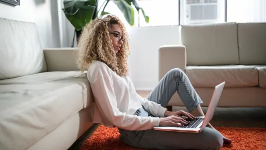 woman on the floor with her laptop