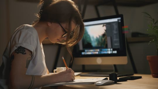 woman writing in her notebook at night