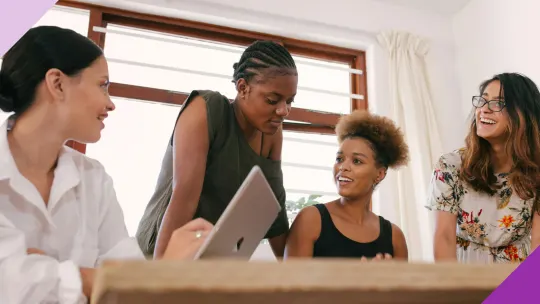 Four in an office women having a conversation, illustrating the importance of active listening at work 