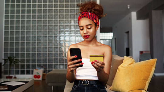 woman with credit card and phone