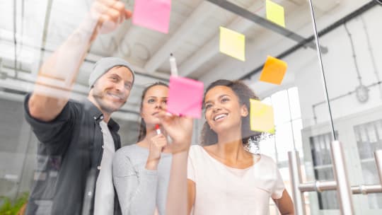 coworkers brainstorming using sticky notes
