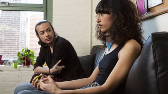 two people sitting at an office